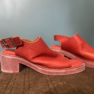 John glue of orange leather shoes